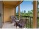 Comfortable screened balcony featuring wicker chairs and views of the outdoors at 603 Cedars Ct, Longboat Key, FL 34228