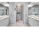 Bright bathroom showcasing dual sinks, modern fixtures, and decorative mirrors at 603 Cedars Ct, Longboat Key, FL 34228