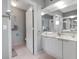 Bathroom featuring a single sink vanity, framed mirrors, and decor with easy access to the toilet at 603 Cedars Ct, Longboat Key, FL 34228