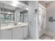 Bathroom featuring a single sink vanity, framed mirrors, and combined shower and bathtub at 603 Cedars Ct, Longboat Key, FL 34228