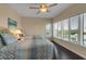 Bright bedroom featuring two twin beds, dark hardwood floors, and a ceiling fan at 603 Cedars Ct, Longboat Key, FL 34228