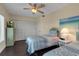 Comfortable bedroom with two twin beds, a TV, and ample closet space at 603 Cedars Ct, Longboat Key, FL 34228