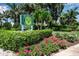 Cedars East Tennis Resort & Club sign is surrounded by beautiful landscaping and palm trees at 603 Cedars Ct, Longboat Key, FL 34228