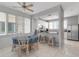 Bright dining area with a table for six and views into the modern kitchen at 603 Cedars Ct, Longboat Key, FL 34228