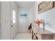 Bright entryway with tile floors, complemented by a stylish wooden table and wall art at 603 Cedars Ct, Longboat Key, FL 34228