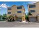 Inviting two-story yellow home with a well-maintained yard and attached garage at 603 Cedars Ct, Longboat Key, FL 34228