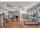 Bright gym with rows of treadmills, wood floors, windows, fans, and other workout equipment at 603 Cedars Ct, Longboat Key, FL 34228
