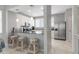 Modern kitchen with stainless steel appliances, granite countertops, and bar seating at 603 Cedars Ct, Longboat Key, FL 34228