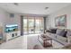Cozy living room with neutral tones, balcony, and a lovely view of the outdoors at 603 Cedars Ct, Longboat Key, FL 34228