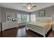 Cozy main bedroom with a large window and plush king bed, with hardwood flooring at 603 Cedars Ct, Longboat Key, FL 34228