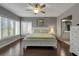 Well-lit bedroom with king bed, bedside tables and lamps, and dark wood flooring throughout at 603 Cedars Ct, Longboat Key, FL 34228