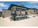 Spacious covered outdoor pool bar with multiple TVs, plenty of seating, and lovely decorations at 603 Cedars Ct, Longboat Key, FL 34228