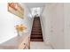 Staircase leading to the upper level, next to an entryway table with flowers at 603 Cedars Ct, Longboat Key, FL 34228