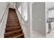 Wood staircase with white railing that flows into the house, with a view of the kitchen at 603 Cedars Ct, Longboat Key, FL 34228