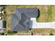 Aerial of house showing roof with complex angles, new driveway, and proximity to the road at 6146 Grandeur St, Englewood, FL 34224