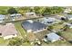 New construction home with a three-car garage, surrounded by a lawn and utility vehicles at 6146 Grandeur St, Englewood, FL 34224