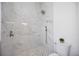 This bathroom features an elegant marble-tiled shower with modern fixtures and stone mosaic flooring at 6146 Grandeur St, Englewood, FL 34224