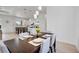 Bright dining room featuring modern light fixtures and a dining table for six at 6146 Grandeur St, Englewood, FL 34224