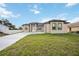 Attractive home showcasing a paved driveway, an attached garage, and vibrant green grass at 6146 Grandeur St, Englewood, FL 34224