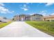 Beautiful home featuring a long driveway, attached garage, and lush green lawn at 6146 Grandeur St, Englewood, FL 34224