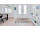 Bright foyer with double front doors, light wood floors, and modern decor at 6146 Grandeur St, Englewood, FL 34224