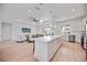 Spacious kitchen and living room featuring a large island with a quartz countertop and stainless steel appliances at 6146 Grandeur St, Englewood, FL 34224