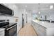Contemporary kitchen featuring stainless steel appliances, modern cabinetry, and a center island at 6146 Grandeur St, Englewood, FL 34224