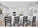 Modern kitchen with white cabinets, stainless steel appliances, and a breakfast bar at 6146 Grandeur St, Englewood, FL 34224