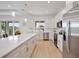 Modern kitchen featuring a large island, stainless steel appliances, and sleek countertops at 6146 Grandeur St, Englewood, FL 34224