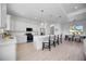 Modern kitchen with white cabinets, stainless steel appliances, and a breakfast bar at 6146 Grandeur St, Englewood, FL 34224