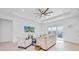 Spacious living room with modern decor, tray ceiling, and abundant natural light at 6146 Grandeur St, Englewood, FL 34224