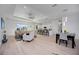 Spacious living area seamlessly connecting to the kitchen and dining space with abundant natural light at 6146 Grandeur St, Englewood, FL 34224