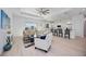 Open-concept living room with bright light, stylish decor, and adjacent kitchen with bar seating at 6146 Grandeur St, Englewood, FL 34224