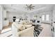 Open-concept living area with views of the kitchen, dining area, and front entry at 6146 Grandeur St, Englewood, FL 34224