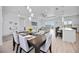 Open concept living space with dining area, white kitchen, and a modern ceiling fan at 6146 Grandeur St, Englewood, FL 34224