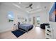 Spacious main bedroom with wood floors, ceiling fan, backyard access, and bright natural light from two windows at 6146 Grandeur St, Englewood, FL 34224