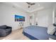 Spacious main bedroom with wood floors, ceiling fan, backyard access, and bright natural light from two windows at 6146 Grandeur St, Englewood, FL 34224
