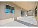 This covered outdoor patio has a ceiling fan with large windows to let in ample light at 6146 Grandeur St, Englewood, FL 34224