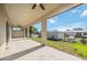 View of the covered outdoor patio featuring a ceiling fan and concrete flooring at 6146 Grandeur St, Englewood, FL 34224
