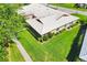 Detailed aerial view of a home with a well-maintained roof, lush lawn, and manicured landscaping, showcasing its curb appeal at 6701 12Th W Ave, Bradenton, FL 34209