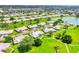 Aerial view shows a community with beautiful landscaping, including a pool and a small lake at 6701 12Th W Ave, Bradenton, FL 34209