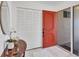 Inviting foyer with a red front door, white closet, and stylish decor setting an elegant tone at 6701 12Th W Ave, Bradenton, FL 34209