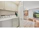 Well-equipped laundry room with washer, dryer, and ample cabinet space, conveniently located near the kitchen and outdoor area at 6701 12Th W Ave, Bradenton, FL 34209