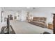 Open-concept living space with neutral carpet and a view into the kitchen at 6701 12Th W Ave, Bradenton, FL 34209