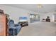 Cozy living room featuring a recliner, TV, and an open view to the sunroom at 6701 12Th W Ave, Bradenton, FL 34209