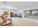 Spacious living room with neutral carpet and a sliding glass door leading to a screened-in lanai at 6701 12Th W Ave, Bradenton, FL 34209