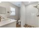 Modern bathroom with white subway tile shower, stone floor detail, and marble-look vanity at 6766 Beedla St, North Port, FL 34291