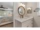 Bright bathroom featuring a white vanity, modern fixtures, and an adjacent bedroom view at 6766 Beedla St, North Port, FL 34291