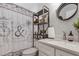 Bathroom with rustic decor, decorative shower curtain, chrome fixtures, and open shelving at 6766 Beedla St, North Port, FL 34291