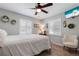 Comfortable bedroom with wood-look tile flooring, neutral walls, chair, and shuttered windows at 6766 Beedla St, North Port, FL 34291